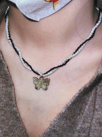 wearing black/white butterfly necklace
