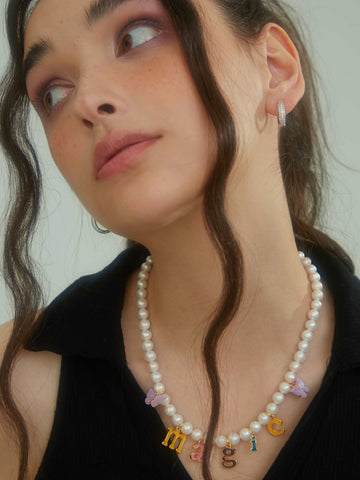 wearing Custom Letter Pearl Necklace and Kaia glitter hoops