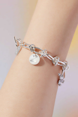 wearing Custom Lucky Charm Initial Bracelet