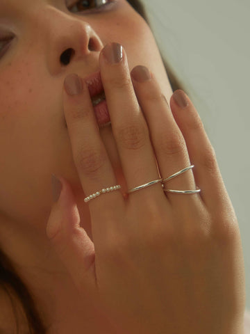 wearing Lena Pearl Beaded Ring and classic silver ring 