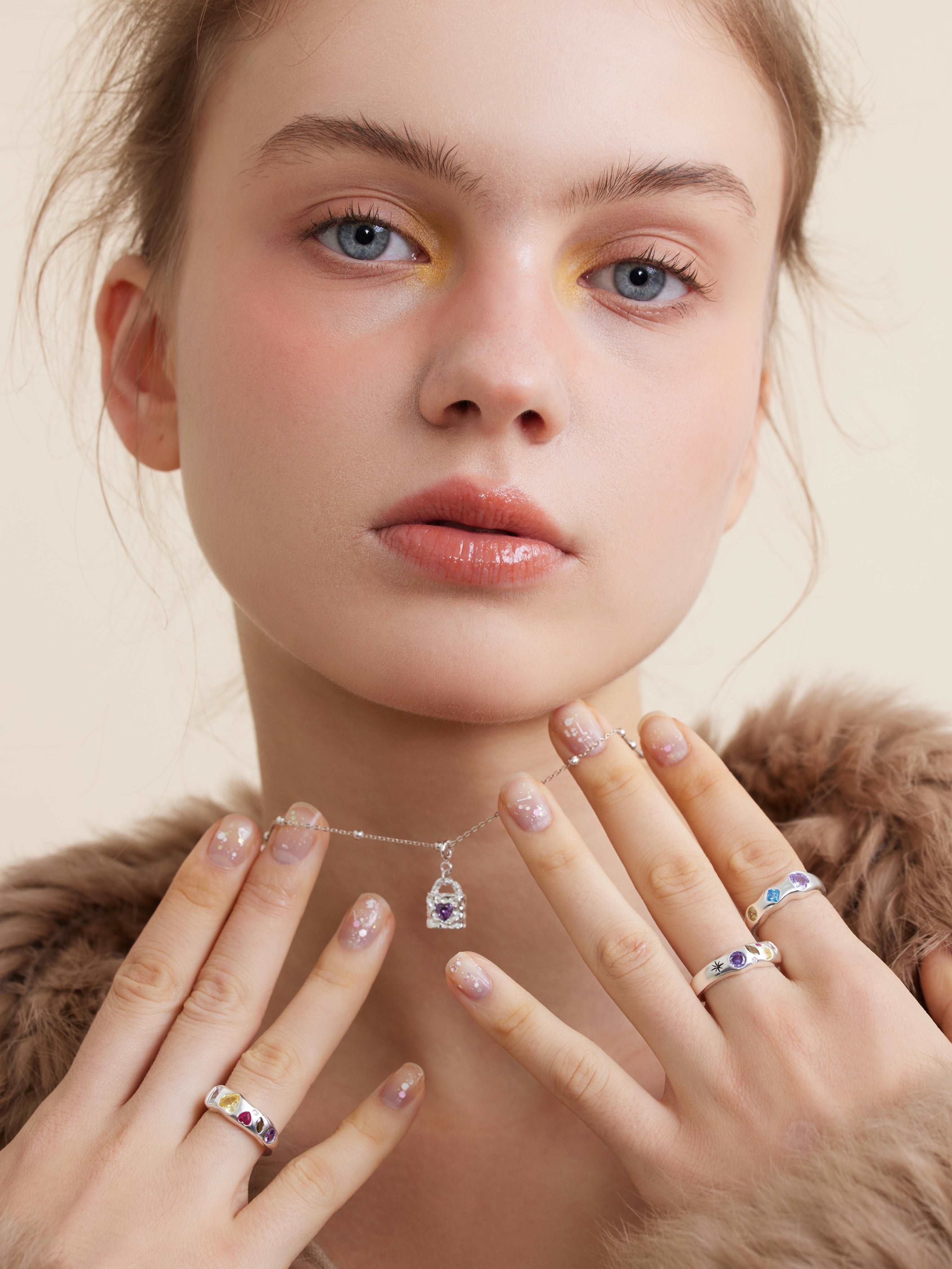 wearing Mini Lock silver Necklace and color astral ring