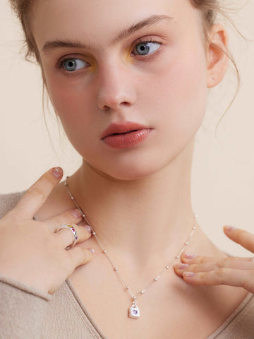 wearing Mini Lock silver Necklace and color astral ring