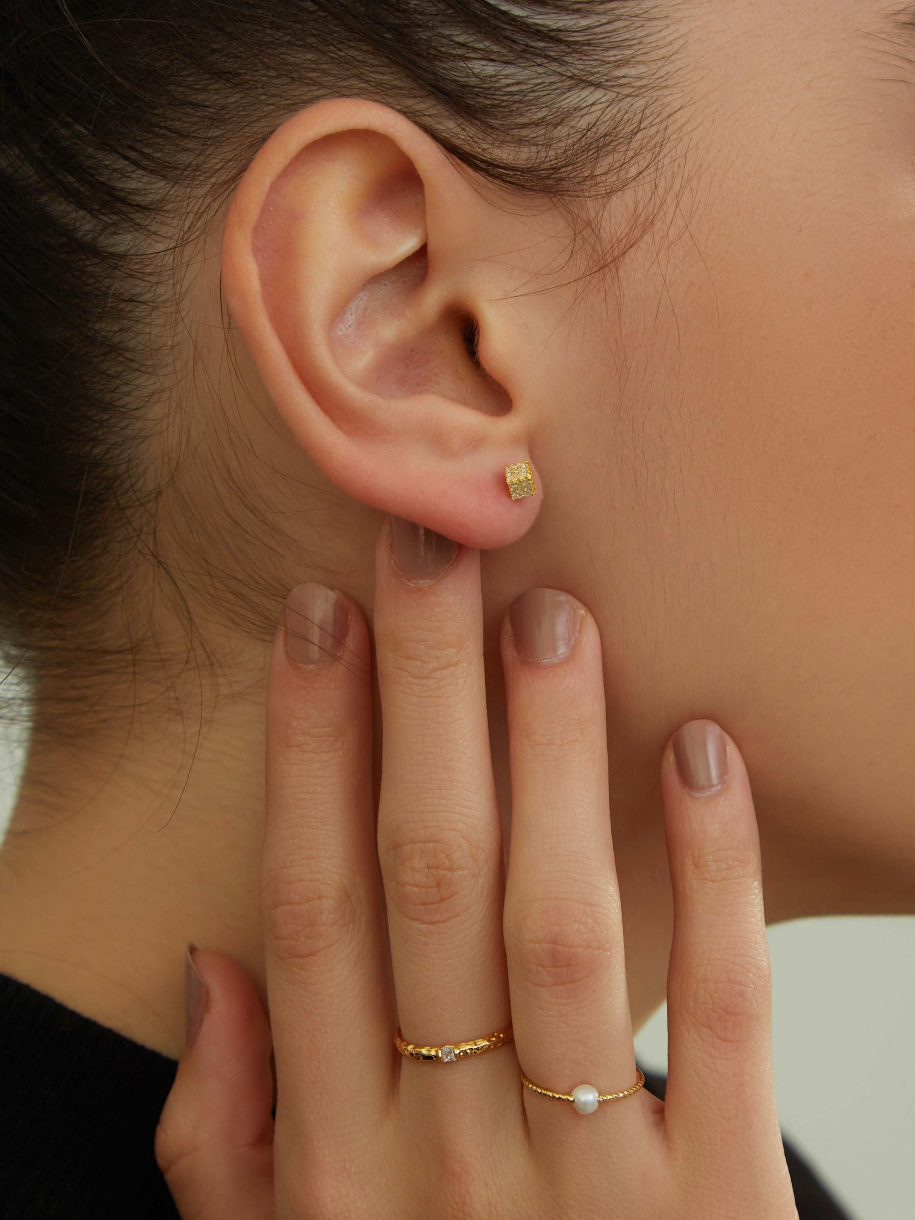 wearing Silver Cube Studs Earrings, thin gold ring and single pearl ring